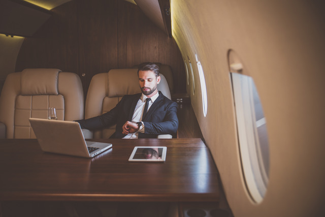 Businessman flying on his private jet